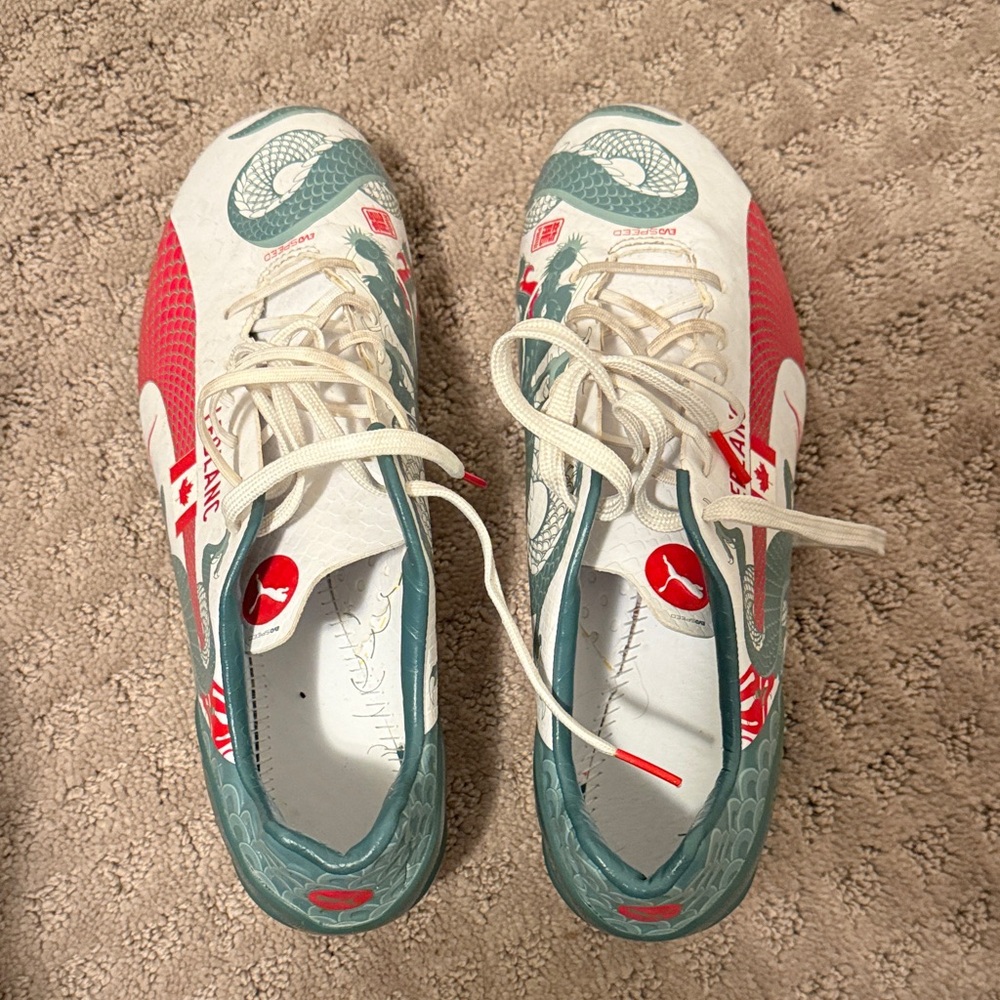 Puma White and Red Soccer Cleats with Green Accents